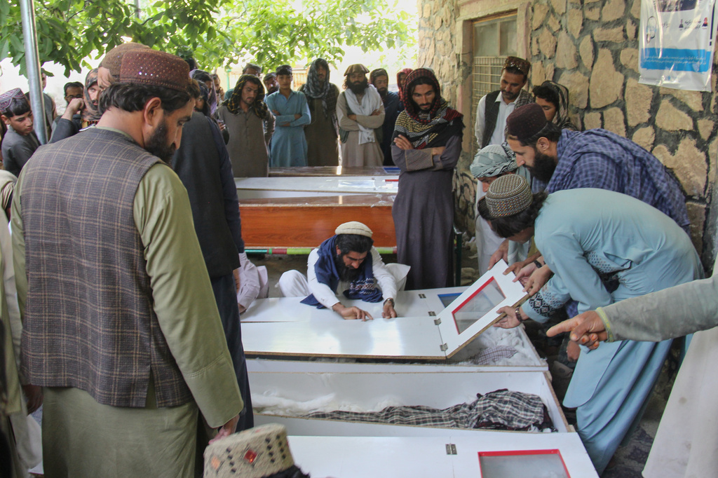 Residents mourn over the coffins of victims, including children, of airstrikes that Taliban officials said were carried out by Pakistan before their funeral in Mana, a village in Afghanistan's Khost province, Wednesday, June 10, 2026. (AP Photo/Saifullah Zahir)