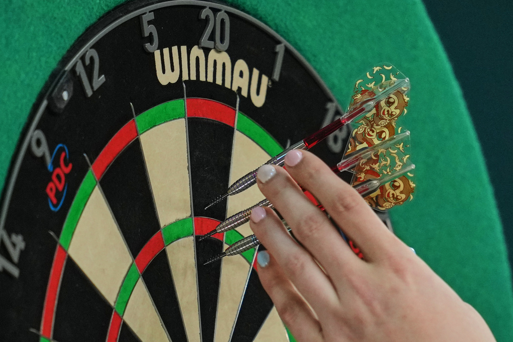 FILE - Noa-Lynn van Leuven, of the Netherlands, takes part in a round one match at the World Darts Championships in London, Monday, Dec. 15, 2025. (AP Photo/Kin Cheung, File)