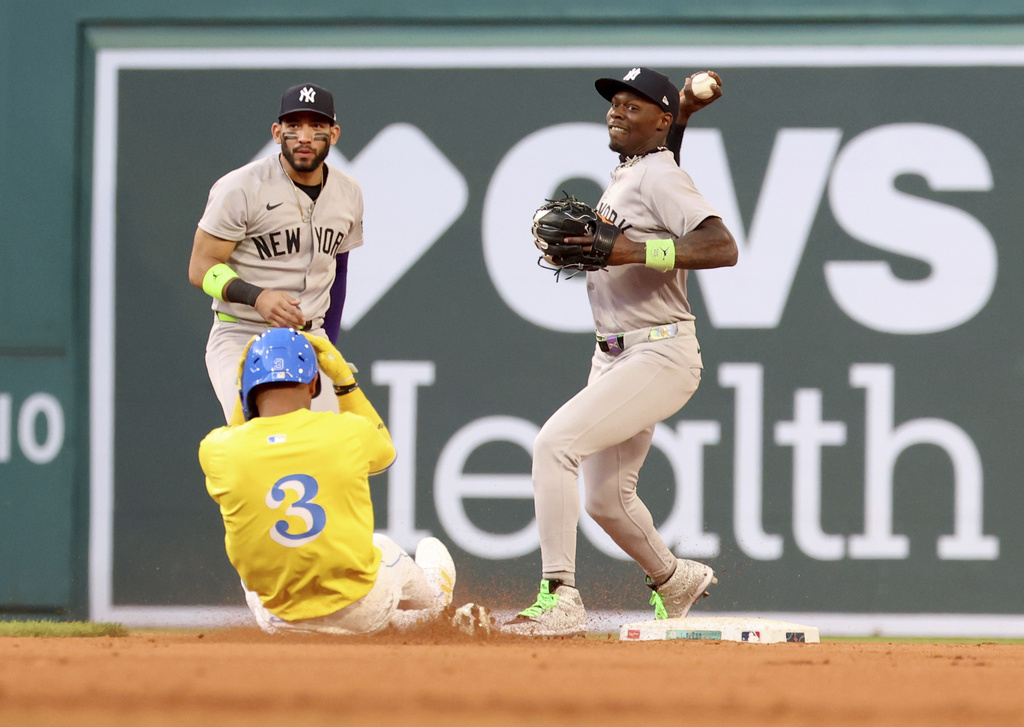 New York Yankees second baseman Jazz Chisholm Jr., right, tags out Boston Red Sox's Ceddanne Rafaela (3) on the front end of a double play during the fifth inning of a baseball game, Saturday, Sept. 13, 2025, in Boston. (AP Photo/Mark Stockwell)