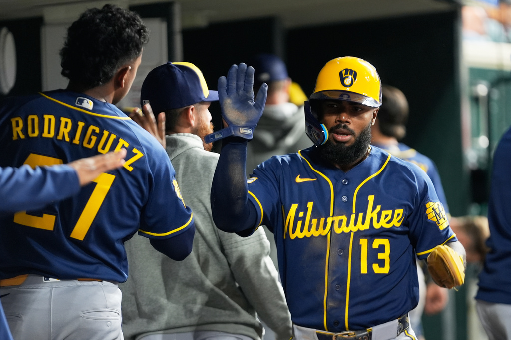 Milwaukee Brewers' Luis Rengifo (13) celebrates after scoring against the Detroit Tigers during the eighth inning of a baseball game Wednesday, April 22, 2026, in Detroit. (AP Photo/Paul Sancya)
