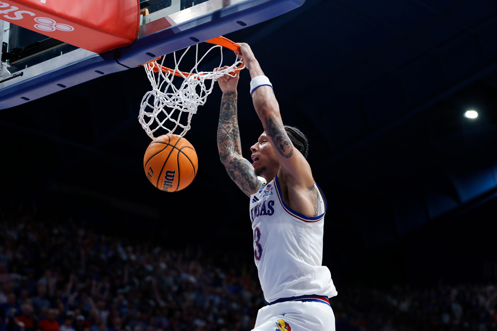 Kansas guard Tre White dunks during the first half of an NCAA college basketball game against Arizona, Monday, Feb. 9, 2026, in Lawrence, Kan. (AP Photo/Colin E. Braley)