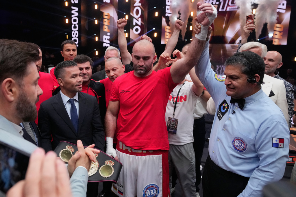 Russia's Murat Gassiev, centre, celebrates after defeating Germany's Peter Kadiru during a WBA Heavyweight world title boxing match as part of the IBA Pro 19 event in Moscow, Russia, Saturday, July. 11, 2026. (AP Photo/Pavel Bednyakov)