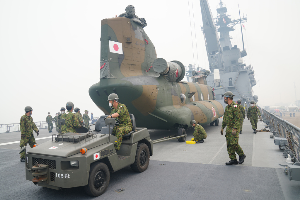 Crew members prepare one of the Chinook helicopters which will be used to help battle forest fires on Kalimantan Island, on the deck of Japanese tank landing ship JS Kunisaki after its arrival at Kijing Port in Mempawah, West Kalimantan, Indonesia, Thursday, Sept. 10, 2026. (AP Photo/Tatan Syuflana)