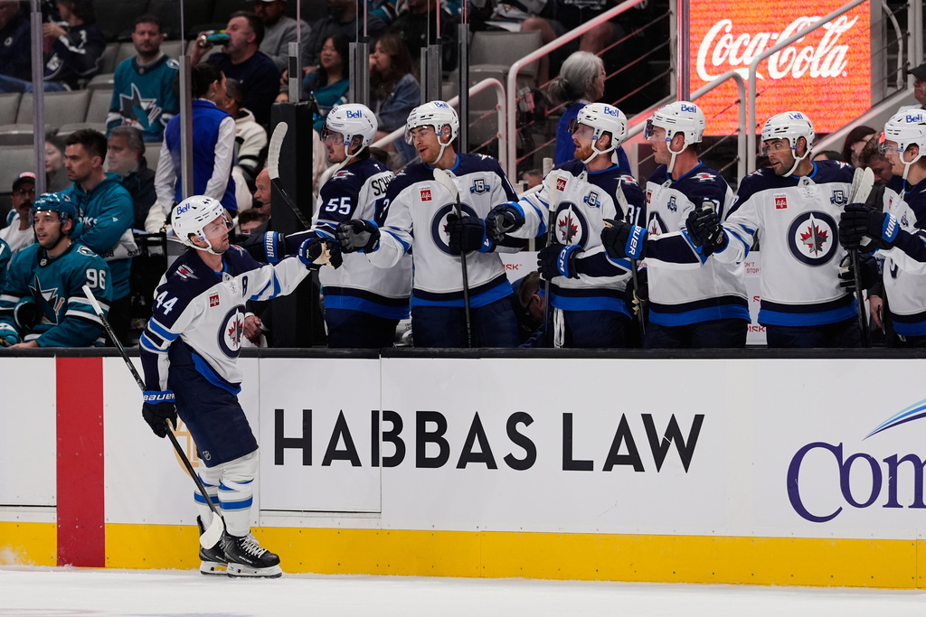 Winnipeg Jets defenseman Josh Morrissey (44) celebrates with teammates after scoring a goal during the first period of an NHL hockey game against the San Jose Sharks, Friday, Nov. 7, 2025, in San Jose, Calif. (AP Photo/Godofredo A. Vásquez)