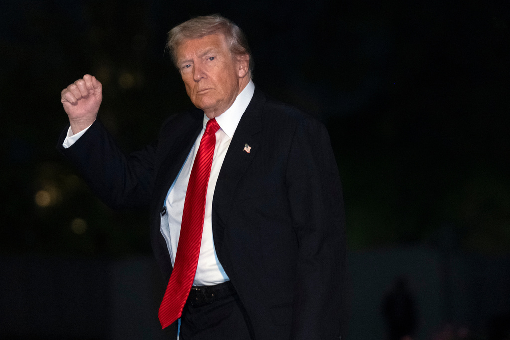 President Donald Trump gestures while walking across the South Lawn of the White House, Sunday, Nov. 2, 2025, in Washington, after returning from a trip to Florida. (AP Photo/Mark Schiefelbein)