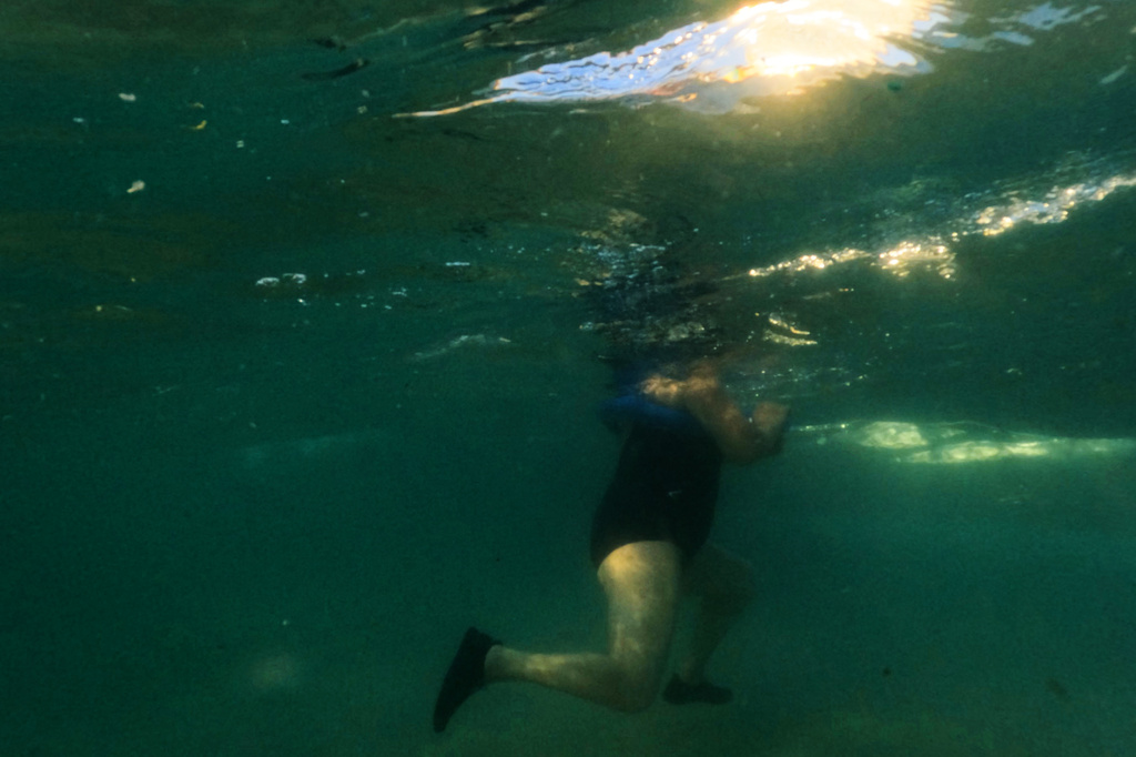 A woman cools off in the Mediterranean sea during a heat wave in Hadera, Israel, Sunday, Aug. 2, 2026. (AP Photo/Ariel Schalit)
