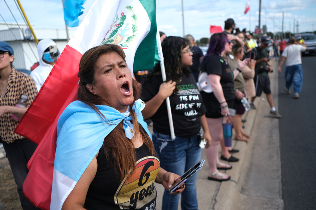 People protest where local authorities say a U.S. Immigration and Customs Enforcement officer (ICE) shot and wounded a man in Austin, Texas, Sunday, Sept. 20, 2026. (AP Photo/Joel Angel Juarez)