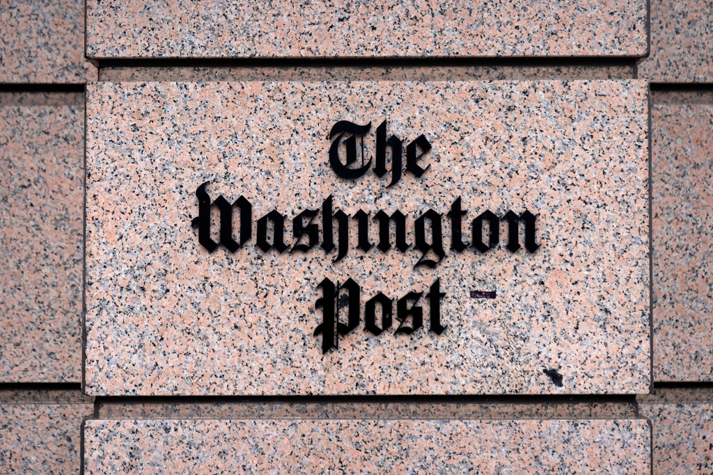 A sign for the Washington Post is seen at the company's offices, Monday, Jan. 26, 2026, in Washington. (AP Photo/Mark Schiefelbein)