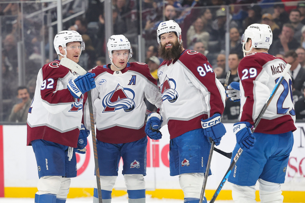 Colorado Avalanche left wing Gabriel Landeskog, left, celebrate with defenseman Cale Makar, defenseman Brent Burns, and center Nathan MacKinnon after scoring during the first period of an NHL hockey game against the Los Angeles Kings Monday, March, 2, 2026 in Los Angeles. (AP Photo/Ryan Sun)