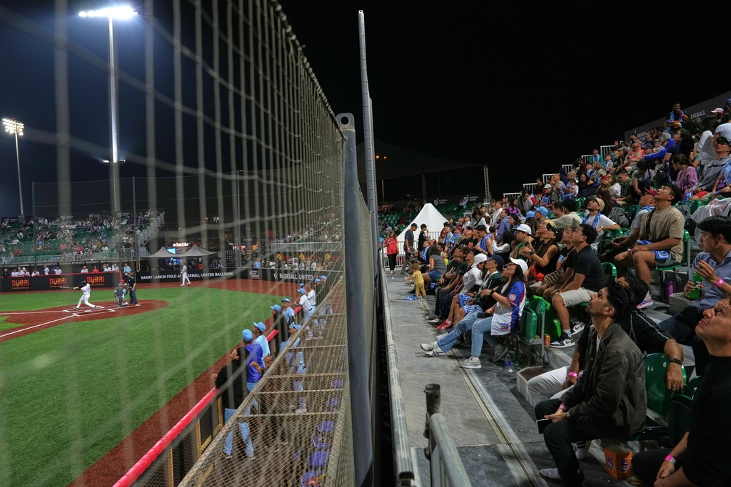 Karachi fans react during the league's opening baseball game at the new Barry Larkin Field in Ud al-Bayda, on the outskirts of Dubai, United Arab Emirates, Friday, Nov. 14, 2025. (AP Photo/Fatima Shbair)