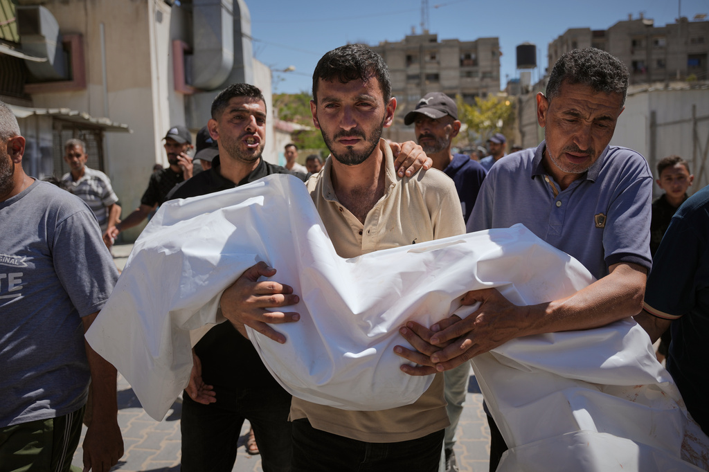 Nabil Abu Labda carries the body of his 6-year-old daughter, Menna Allah Abu Labda, who was killed in an Israeli airstrike, during her funeral at Nasser Hospital in Khan Younis, Gaza Strip, Monday, May 25, 2026. (AP Photo/Abdel Kareem Hana)