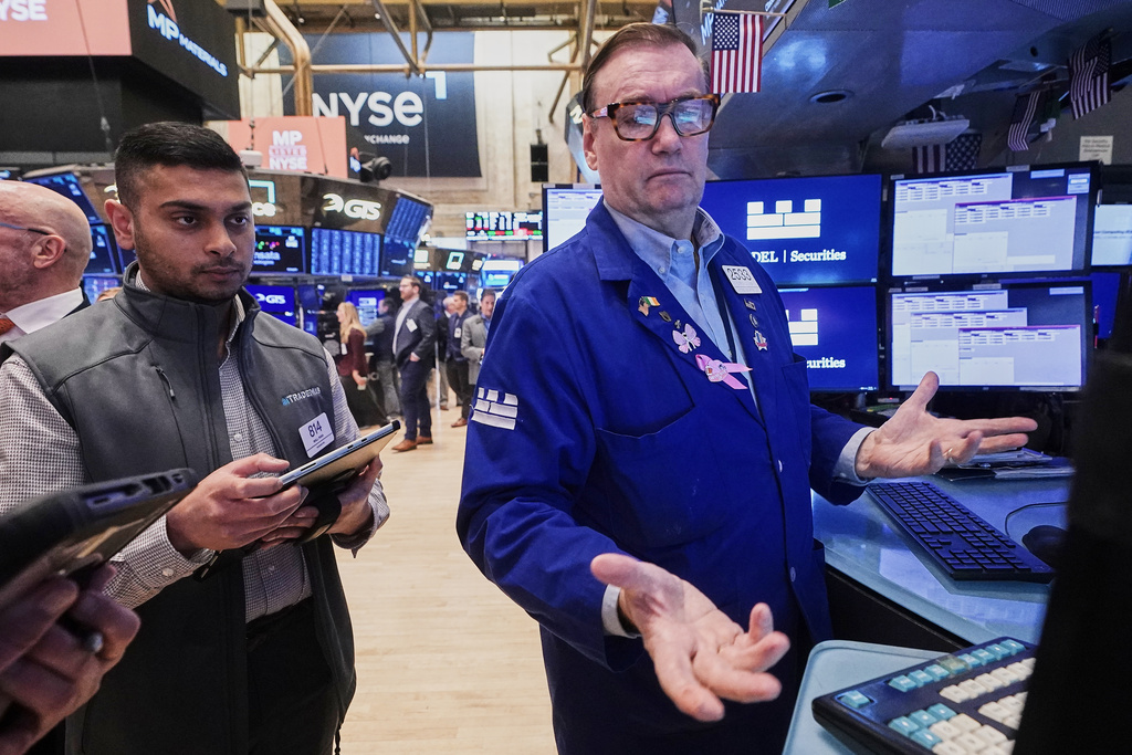 Trader Niall Pawa, left, and specialist Patrick King work on the floor of the New York Stock Exchange, Tuesday, Nov. 18, 2025. (AP Photo/Richard Drew)