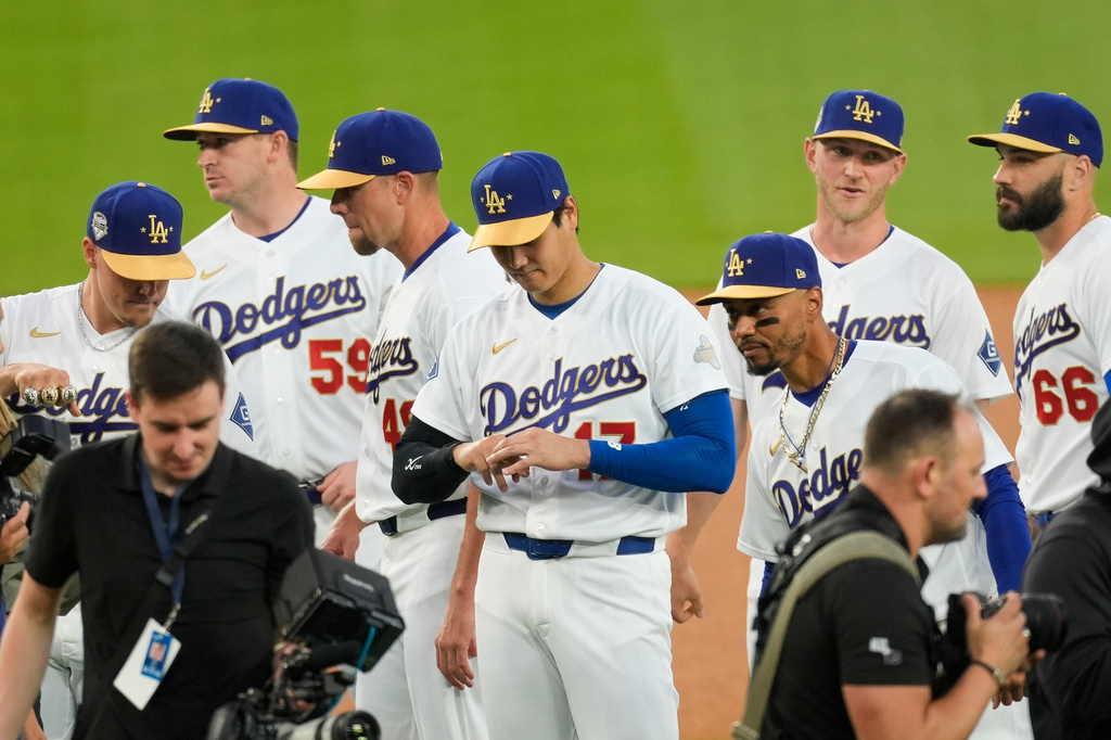 Los Angeles Dodgers Shohei Ohtani adjusts his ring during a World Series Champion ring ceremony prior to a baseball game against the Arizona Diamondbacks in Los Angeles, Friday, March 27, 2026. (AP Photo/Caroline Brehman)