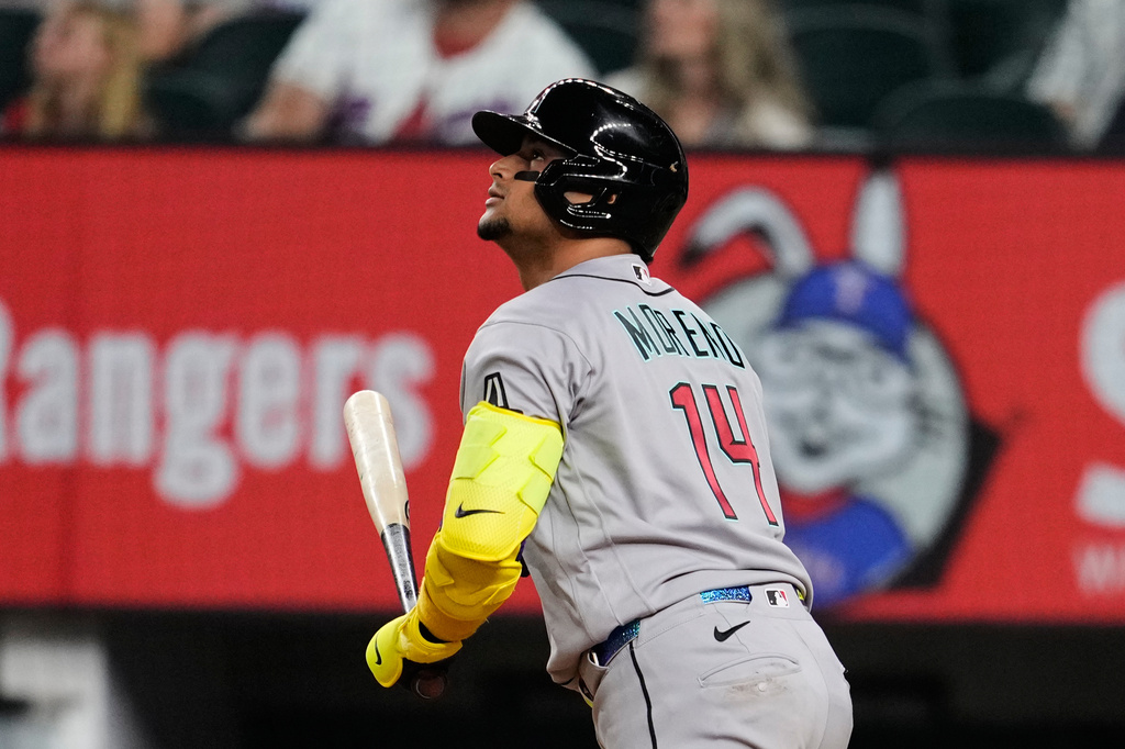 Arizona Diamondbacks' Gabriel Moreno watches his sacrifice fly that scored Nolan Arenado in the ninth inning of a baseball game against the Texas Rangers Tuesday, May 12, 2026, in Arlington, Texas. (AP Photo/Tony Gutierrez)