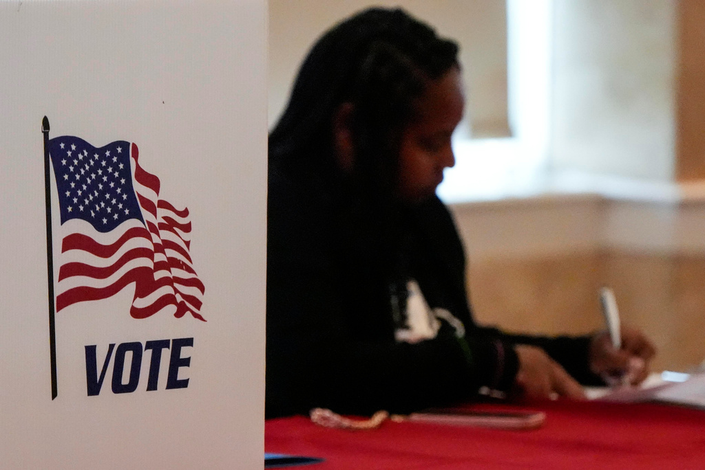 A Fulton County staff member works as people vote in a runoff election, Tuesday, June 16, 2026, in Atlanta. (AP Photo/Mike Stewart)