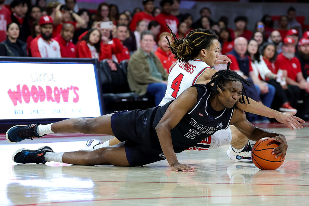 Jackson State Tigers guard Delyle Williams (12) and Houston Cougars guard Kingston Flemings (4) battle for a loose ball during first half of an NCAA college basketball game, Wednesday, Dec 10, 2025, in Houston. (AP Photo/Maria Lysaker)