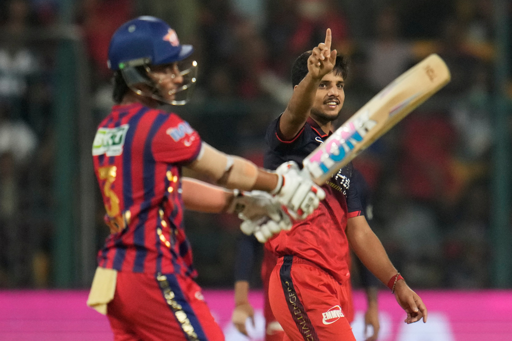 Royal Challengers Bengaluru's Rasikh Dar, right, celebrates the dismissal of Lucknow Super Giants' Ayush Badoni, left, during the Indian Premier League cricket match between Royal Challengers Bengaluru and Lucknow Super Giants in Bengaluru, India, Wednesday, April 15, 2026. (AP Photo/Aijaz Rahi)