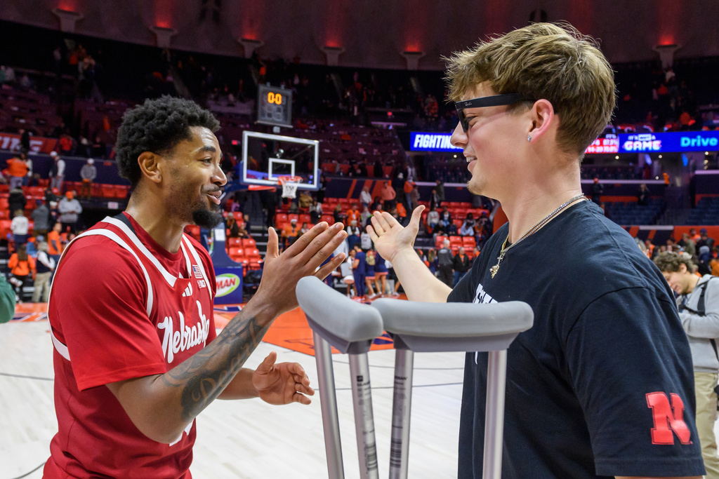 Nebraska' Jamarques Lawrence celebrates a win over Illinois with teammate Connor Essegian after an NCAA college basketball game Saturday, Dec. 13, 2025, in Champaign, Ill. (AP Photo/Craig Pessman)