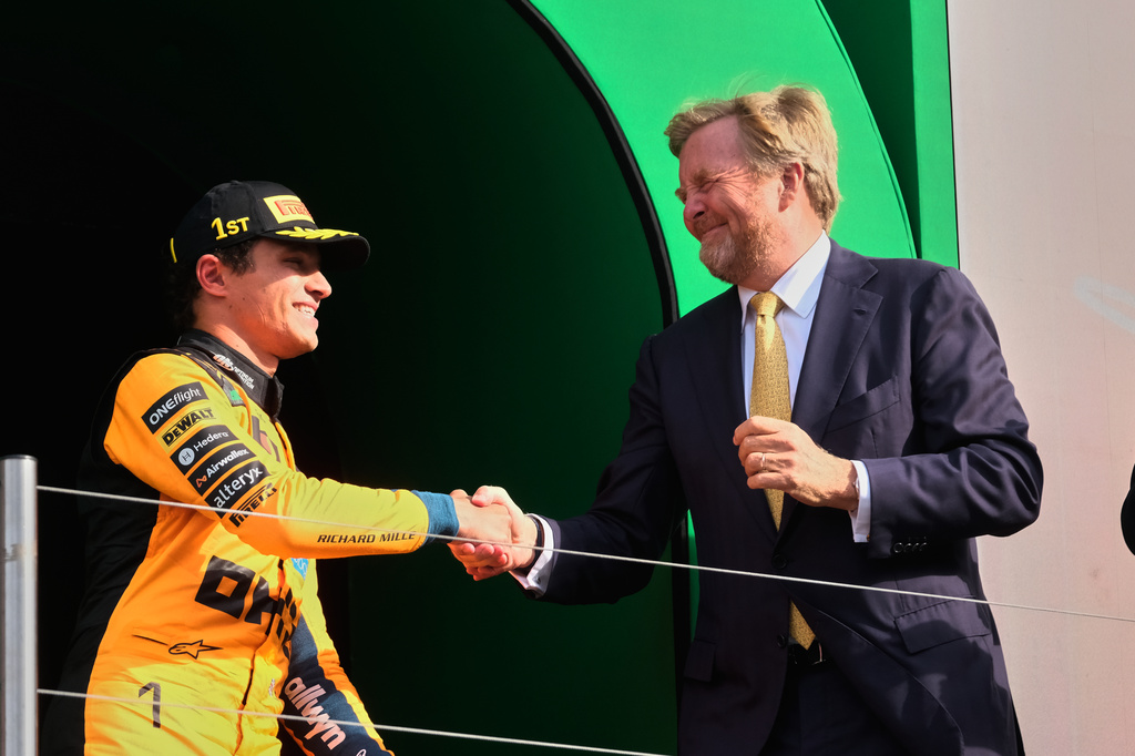 McLaren driver Lando Norris of Britain shakes hands with the King of the Netherlands Willem-Alexander after he Formula One Dutch Grand Prix in Zandvoort , Netherlands, Sunday, Aug. 23, 2026. (AP Photo/Patrick Post)