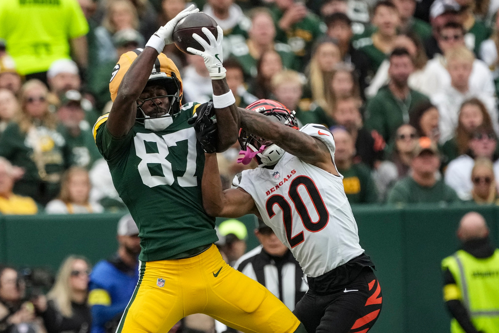 Green Bay Packers wide receiver Romeo Doubs (87) works for a catch against Cincinnati Bengals cornerback DJ Turner II (20) in the first half of an NFL football game, Sunday, Oct. 12, 2025, in Green Bay, Wis. (AP Photo/Morry Gash)