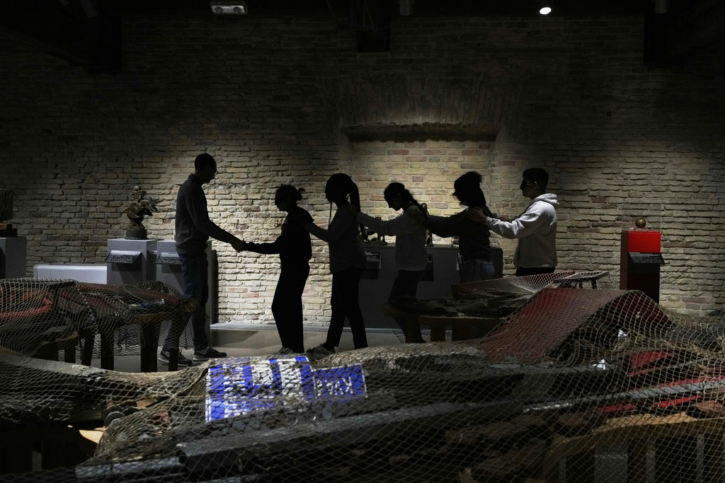 Blindfolded students of an art high school enter the pavilion of contemporary art for a project on tactile experience at the Omero Tactile Museum in Ancona, Italy, Friday, Jan. 16, 2026. (AP Photo/Alessandra Tarantino)
