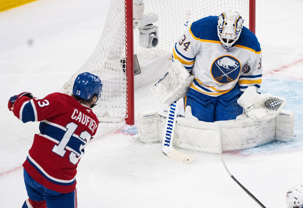 Buffalo Sabres goaltender Alex Lyon (34) makes a save against Montreal Canadiens' Cole Caufield (13) during the first period of Game 3 in a second-round NHL hockey Stanley Cup playoff series in Montreal, Sunday, May 10, 2026. (Christinne Muschi/The Canadian Press via AP)