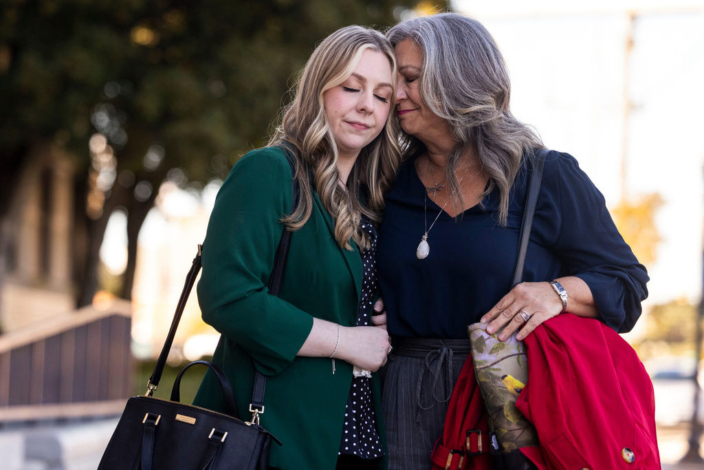 Abby Zwerner shares a moment with her mother Julie Zwerner after a verdict was reached in her lawsuit against the assistant principal, Ebony Parker, of Richneck Elementary School during proceedings at Newport News Circuit Court in Newport News, Va. on Thursday, Nov. 6, 2025. (Kendall Warner/The Virginian-Pilot via AP)