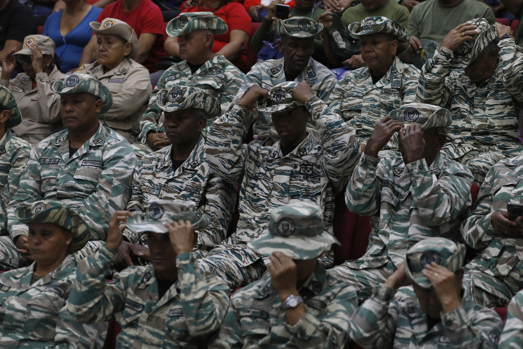 Members of the Bolivarian Militiaslisten to a recorded speech by President Nicolás Maduro at a military garrison in Caracas, Venezuela, Friday, Sept. 5, 2025. (AP Photo/Cristrian Hernandez)