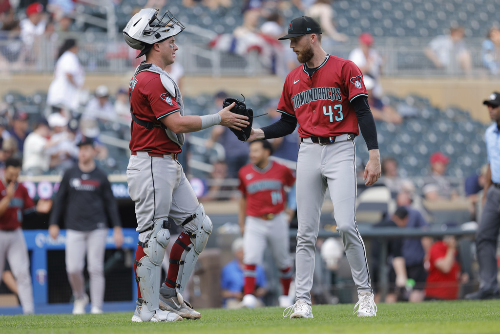 Arizona Diamondbacks closing pitcher Kyle Backhus (43) celebrates with catcher James McCann after winning a baseball game against the Minnesota Twins, Sunday, Sept. 14, 2025, in Minneapolis. (AP Photo/Bailey Hillesheim)