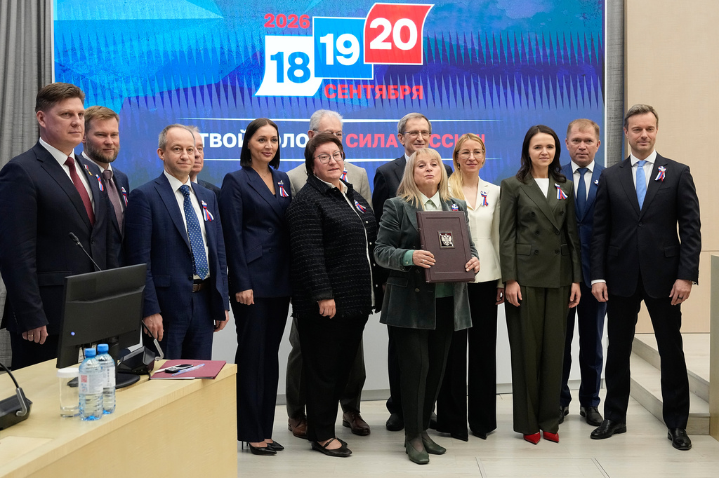Ella Pamfilova, head of Russia's Central Election Commission, center right, poses for a photo with members of the Central Election Commission after reporting the official results of Russia's parliamentary elections at the commission's meeting in Moscow, Russia, Friday, Sept. 25, 2026. (AP Photo/Alexander Zemlianichenko)