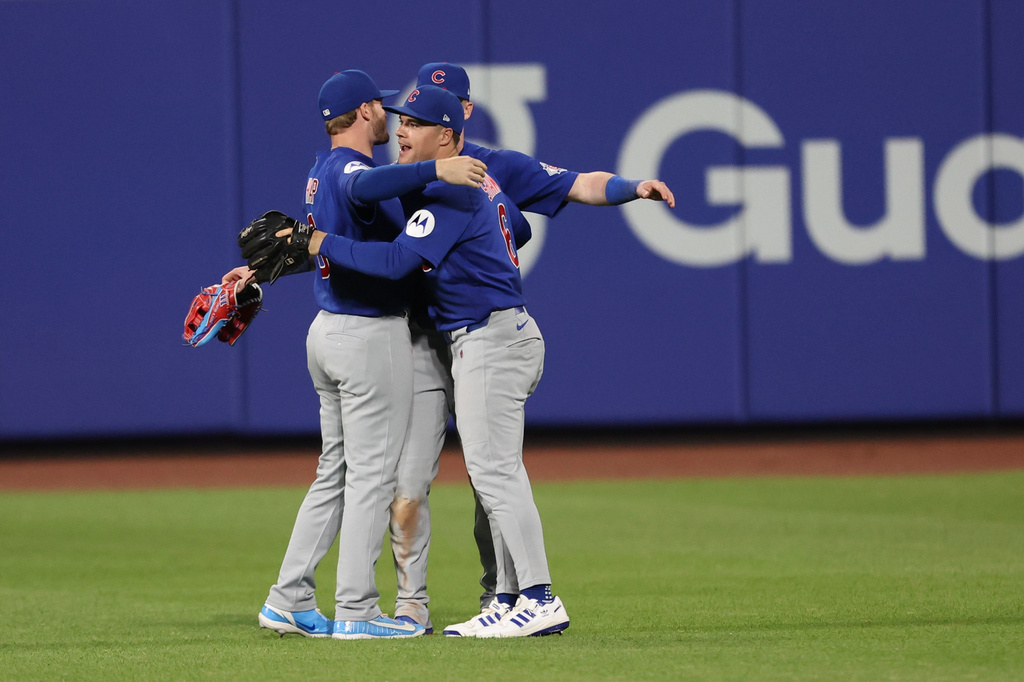 Chicago Cubs left fielder Ian Happ, left, Pete Crow-Armstrong, center, and Matt Shaw (6) celebrate a win in the tenth inning of a baseball game against the New York Mets, Thursday, June 25, 2026, in New York. (AP Photo/Heather Khalifa)
