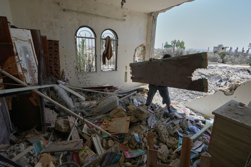 A Lebanese man removes debris from his destroyed house in the village of Zawtar al-Gharbieh, south Lebanon, Wednesday, Aug. 5, 2026. (AP Photo/Mohammed Zaatari)