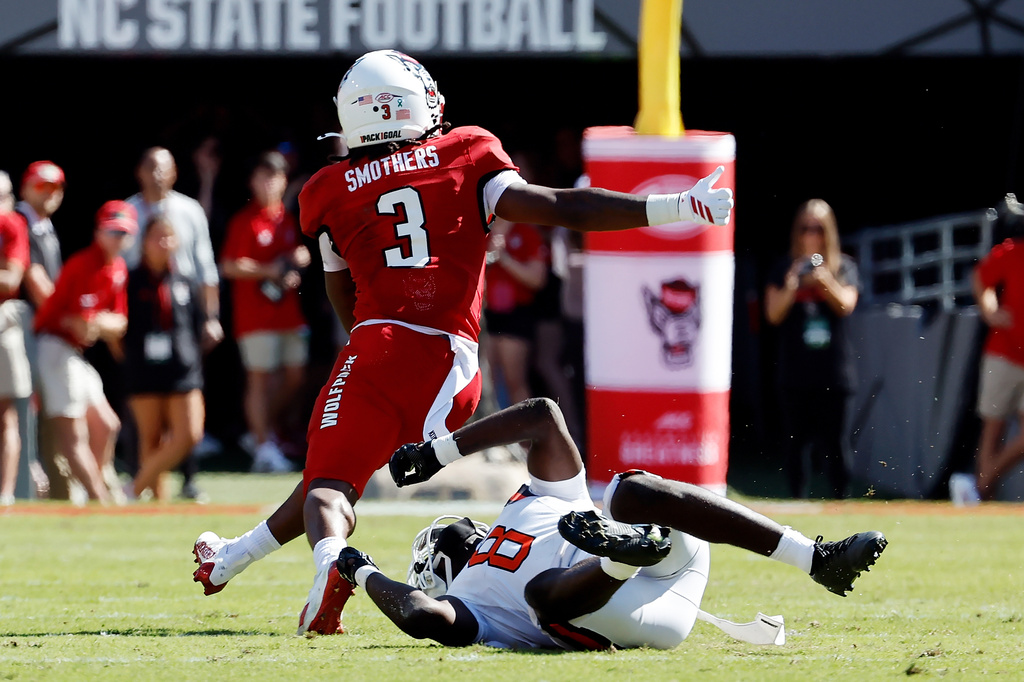North Carolina State running back Hollywood Smothers (3) breaks the tackle of Campbell's Jojo Pace (8) on his way to a touchdown during the first half of an NCAA college football game in Raleigh, N.C., Saturday, Oct. 4, 2025. (AP Photo/Karl DeBlaker)
