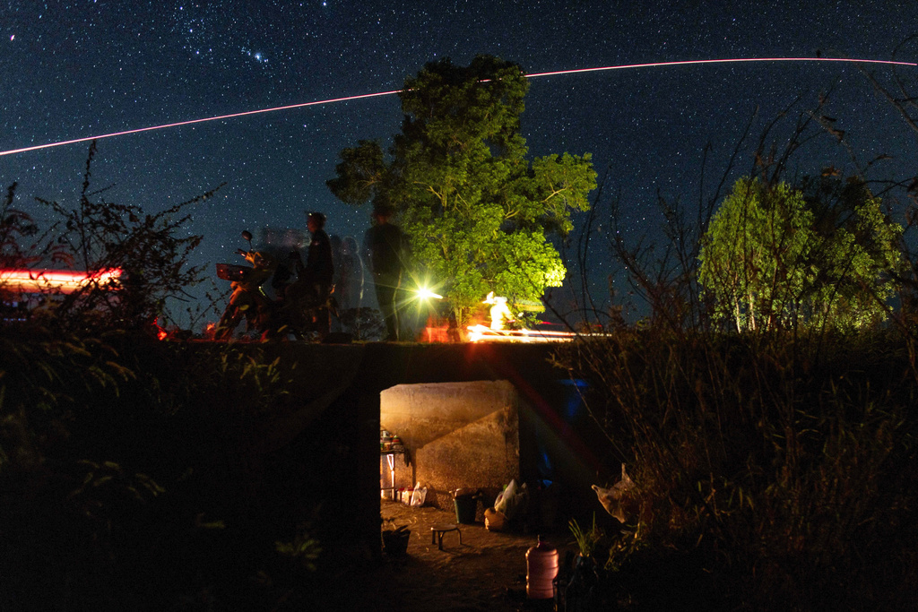 Village security volunteer patrol while Thai military fires artillery towards Cambodia, Saturday, Dec. 20, 2025, in Surin province, Thailand. (AP Photo/Wason Wanichakorn)