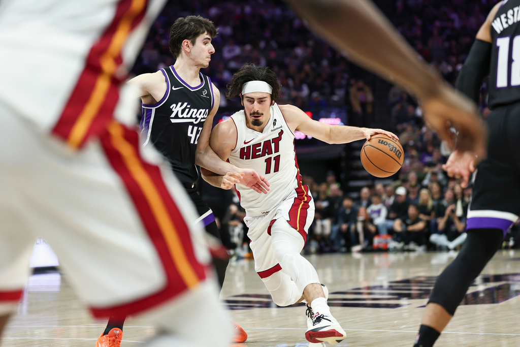 Miami Heat forward Jaime Jaquez Jr. (11) drives to the basket with Sacramento Kings center Maxime Raynaud (42) defending during the first half of an NBA basketball game Tuesday, Jan. 20, 2026, in Sacramento, Calif. (AP Photo/Sara Nevis)