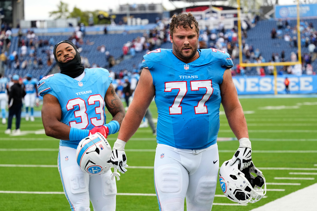 1Tennessee Titans linebacker Cedric Gray (33) and guard Peter Skoronski (77) walk off the field after an NFL football game against the Houston Texans in Nashville, Tenn., Sunday, Oct. 11, 2026. (AP Photo/George Walker IV)