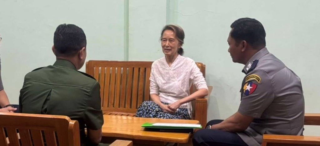 In this undated photo provided on April 30, 2026, by the Myanmar Military True News Information Team, the country's former leader Aung San Suu Kyi, center, talks with officials in an undisclosed location in Myanmar. (Myanmar Military True News Information Team via AP)