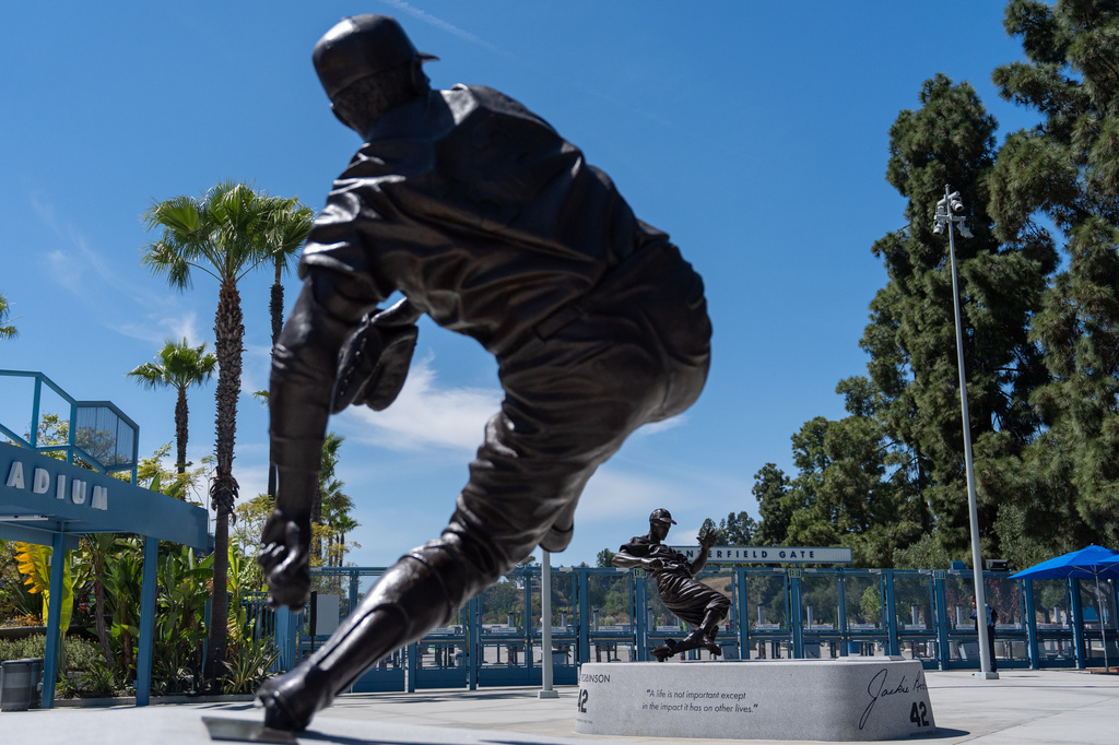 Statues of Sandy Koufax, foreground, and Jackie Robinson stand outside Dodger Stadium before a baseball game between the Los Angeles Dodgers and the New York Mets, Wednesday, April 15, 2026, in Los Angeles. (AP Photo/Jae C. Hong)