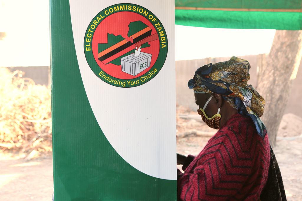FILE - A woman is seen in a voting booth at a polling station in Lusaka, Zambia, Aug, 12, 2021. (AP Photo/Tsvangirayi Mukwazhi, File)