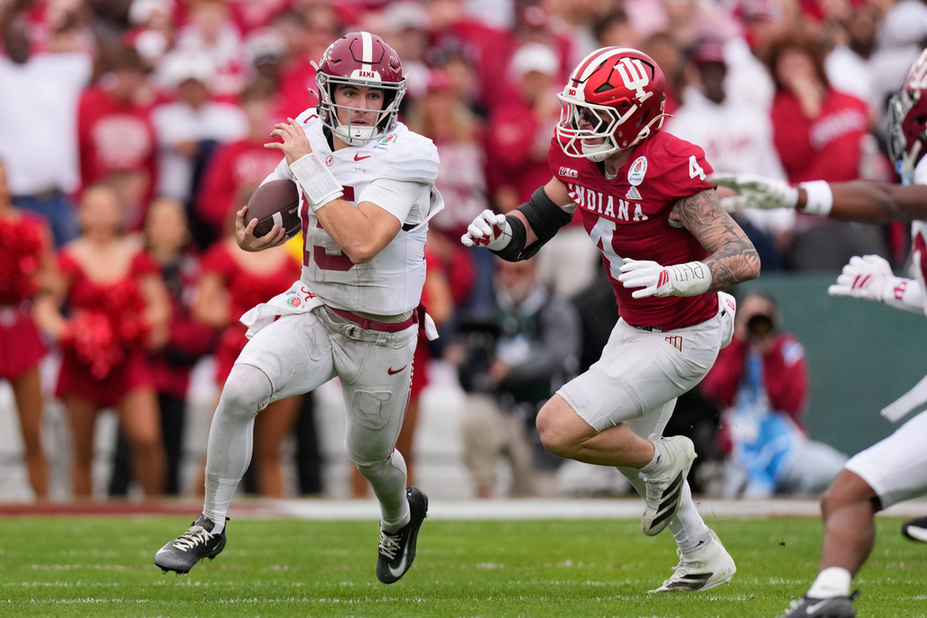 Alabama quarterback Ty Simpson (15) is chased by Alabama linebacker Qua Russaw (4) during the first half of the Rose Bowl College Football Playoff quarterfinal game Thursday, Jan. 1, 2026, in Pasadena, Calif. (AP Photo/Mark J. Terrill)