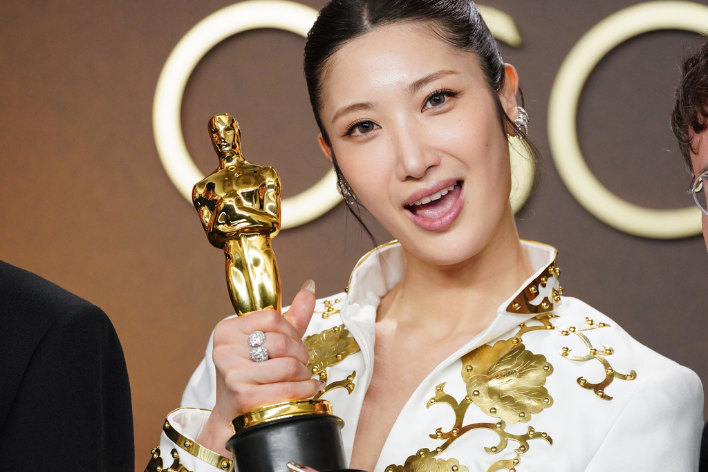 EJAE, winner of the award for music (original song) for "Golden" from "K-pop Demon Hunters," poses in the press room at the Oscars on Sunday, March 15, 2026, at the Dolby Theatre in Los Angeles. (Photo by Jordan Strauss/Invision/AP)