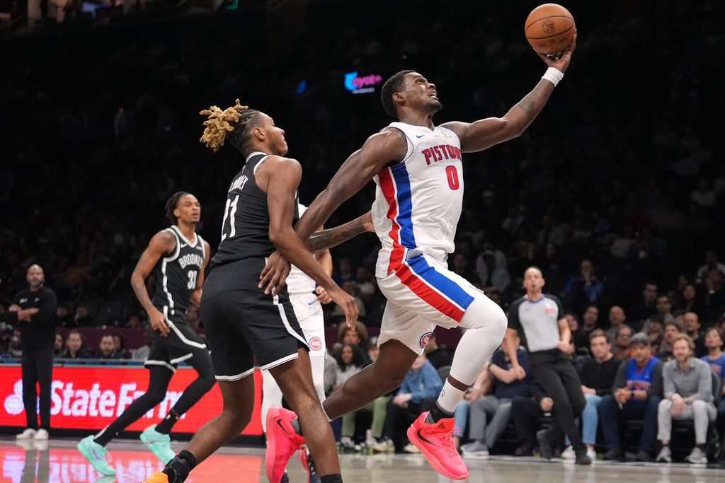 Detroit Pistons' Jalen Duren (0) drives past Brooklyn Nets' Noah Clowney (21) during the first half of an NBA basketball game Tuesday, March 10, 2026, in New York. (AP Photo/Frank Franklin II)