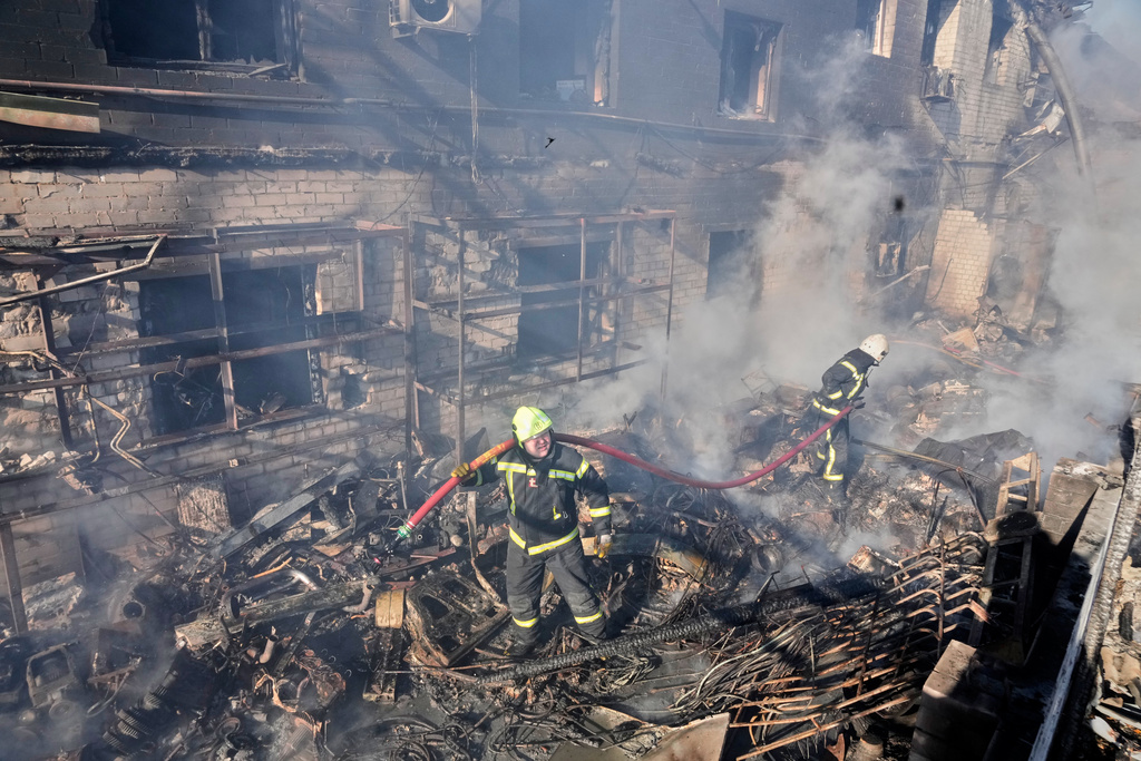 Firefighters put out the fire at a residential neighbourhood following a Russia missile and drone attack, in Brovary, close to Kyiv, Ukraine, Saturday, March 14, 2026. (AP Photo/Efrem Lukatsky)