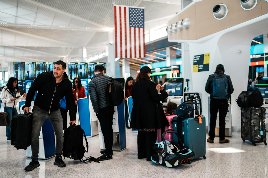 People arrive to queue in a TSA security line at Terminal A of Newark Liberty International Airport (EWR) in Newark, N.J., Tuesday, March 24, 2026. (AP Photo/Eduardo Munoz Alvarez)