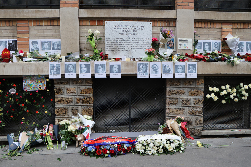 Flowers and photographs of victims near are placed near La Bonne Biere cafe, Thursday Nov. 13, 2025 in Paris as part of ceremonies marking the 10th anniversary of terrorist attacks that killed 132 people and injured hundreds. (Ludovic Marin, Pool photo via AP)