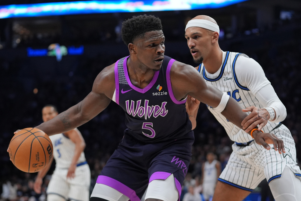 Minnesota Timberwolves guard Anthony Edwards (5) works toward the basket as Orlando Magic guard Jalen Suggs (4) defends during the first half of an NBA basketball game, Saturday, March 7, 2026, in Minneapolis. (AP Photo/Abbie Parr)