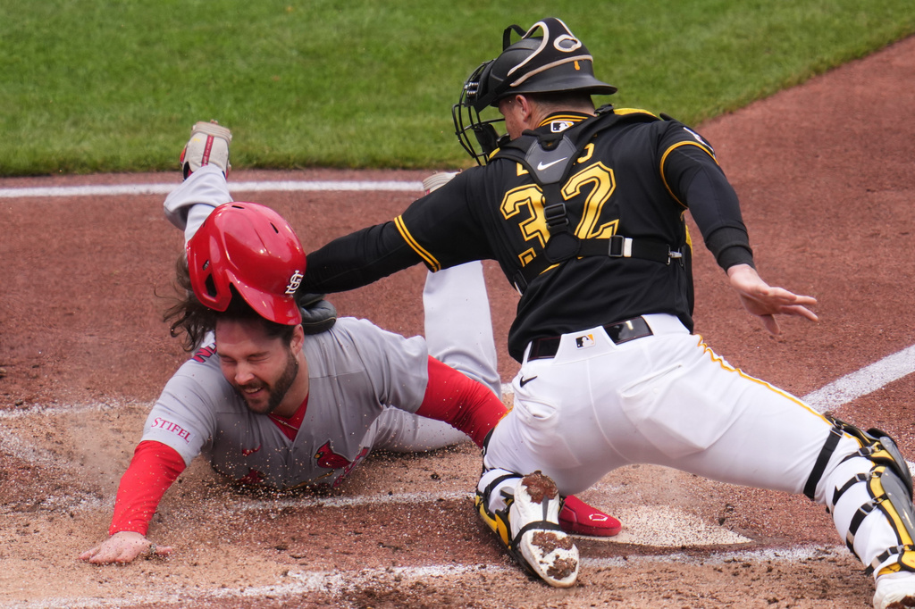 St. Louis Cardinals' Alec Burleson, left, slides safely under the tag by Pittsburgh Pirates catcher Henry Davis to score on a single by Nolan Gorman during the third inning of a baseball game in Pittsburgh, Thursday, April 30, 2026. (AP Photo/Gene J. Puskar)