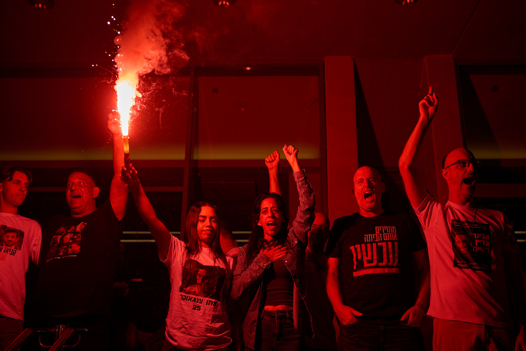Einav Zangauker, center, mother of Matan Zangauker, who is being held hostage by Hamas, celebrates along with other families and supporters of Israeli hostages after the announcement that Israel and Hamas have agreed to the first phase of a peace plan, as they gather at a plaza known as the hostages square in Tel Aviv, Israel, Thursday, Oct. 9, 2025. (AP Photo/Ohad Zwigenberg)