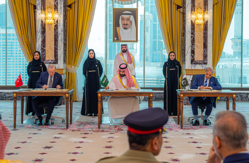 From left, Turkish President Recep Tayyip Erdogan, Saudi Crown Prince Mohammed bin Salman and Pakistani Prime Minister Shehbaz Sharif sign a trilateral defense agreement in Mecca, Saudi Arabia, Friday, Aug. 7, 2026. (Saudi Press Agency via AP)