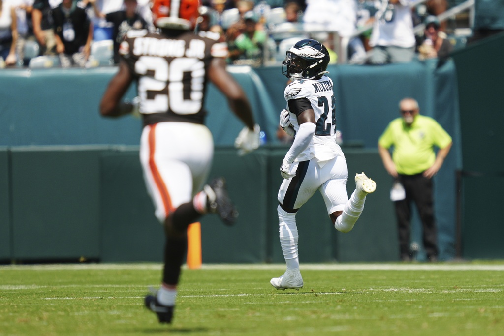 Philadelphia Eagles' Andrew Mukuba (24) looks back at Cleveland Browns running back Pierre Strong Jr. (20) as he runs for a touchdown after an interception during the first half of an NFL preseason football game Saturday, Aug. 16, 2025, in Philadelphia. (AP Photo/Derik Hamilton)